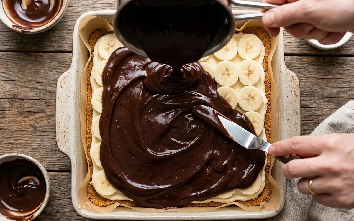 Step 10: Pour the ganache over the bananas and spread carefully to co